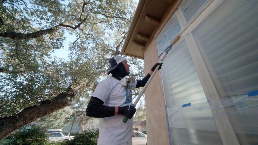 Painting services taking place on a stucco repair job in Houston, Texas - That 1 Painter Houston