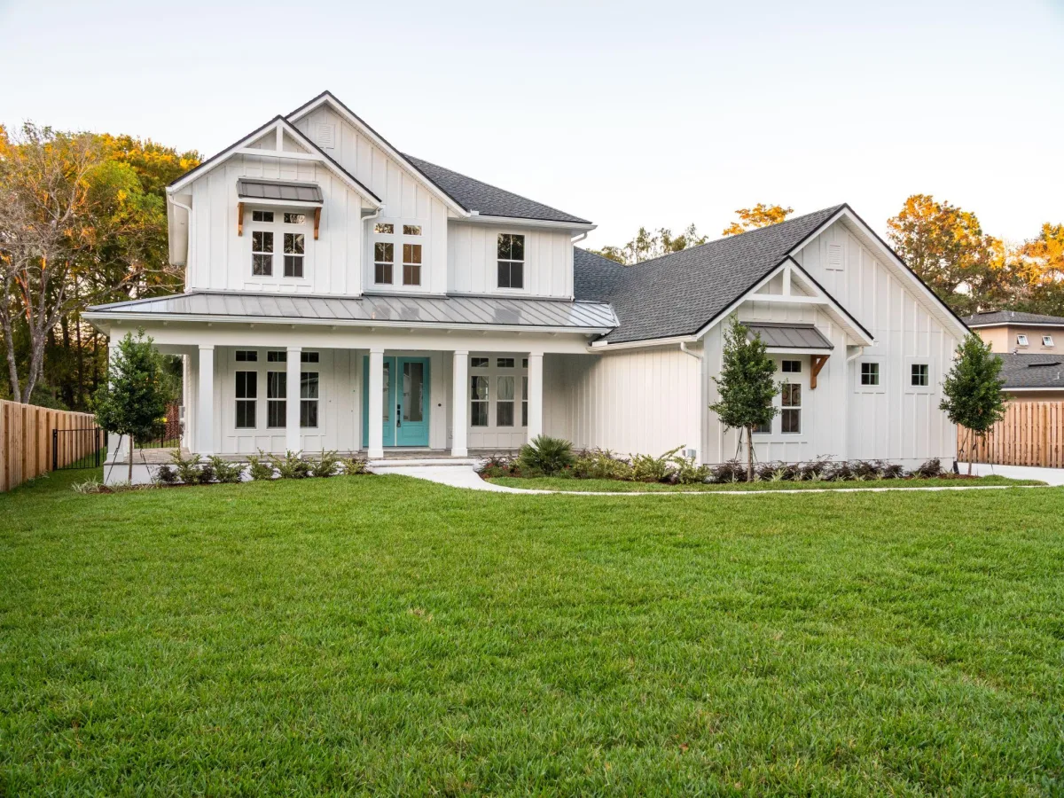 Two-story white house exterior with landscaped yard