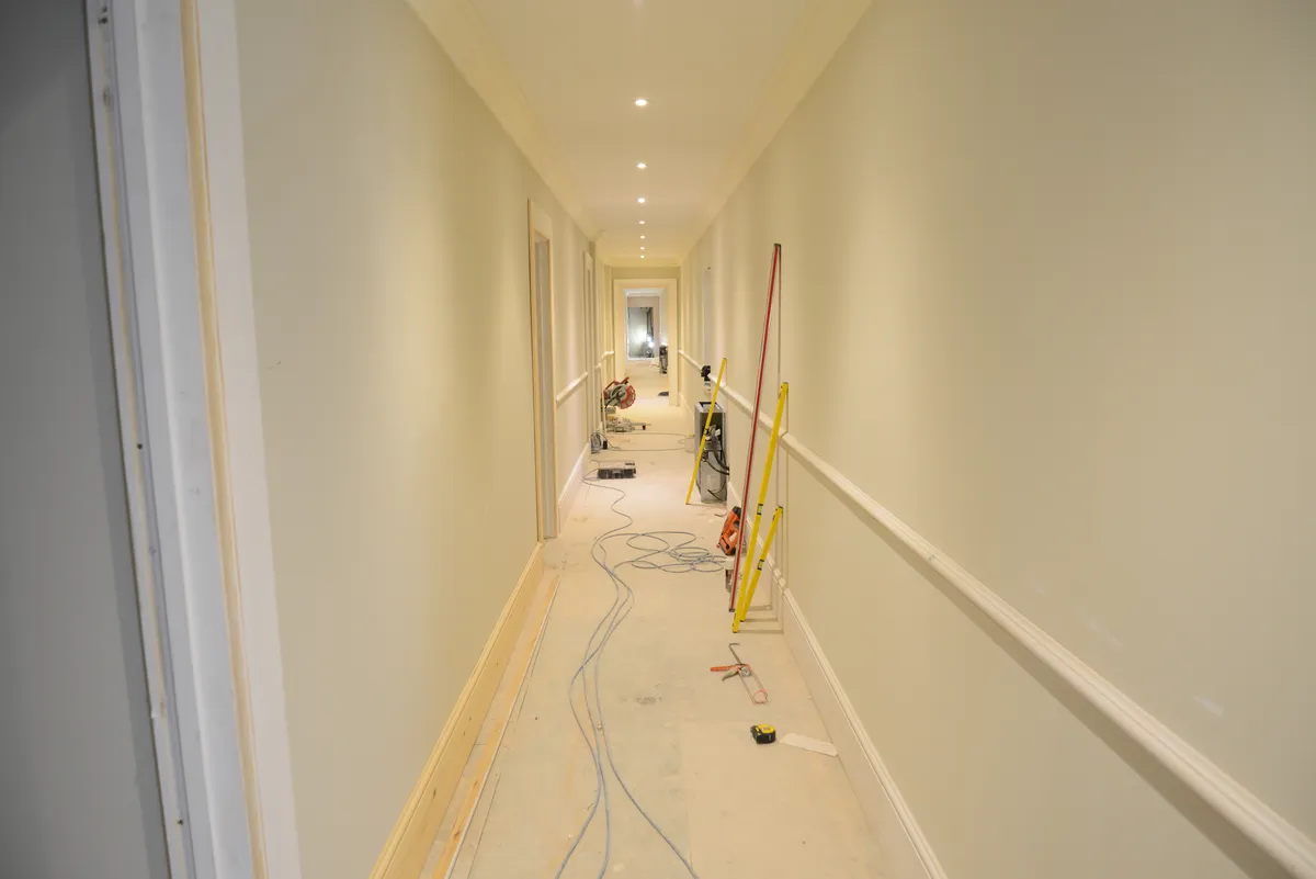 Long freshly painted hallway with white walls and trim