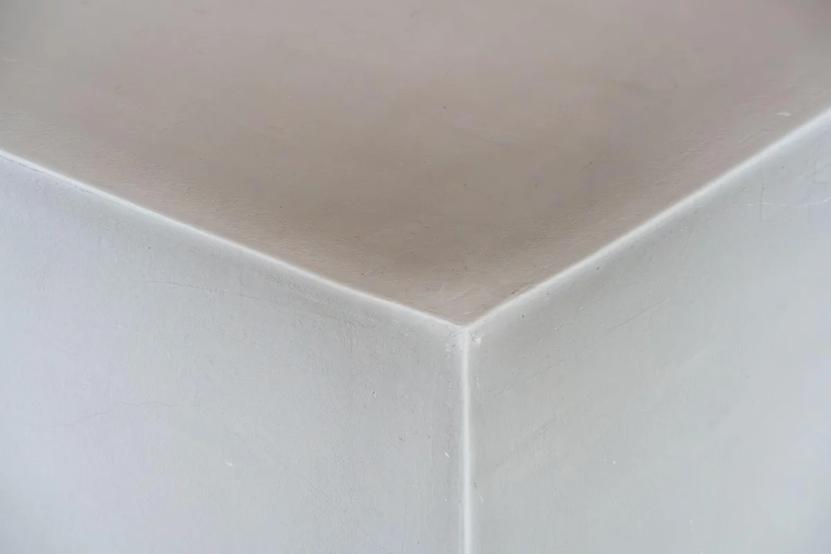 Clean, freshly painted white ceiling corner where two walls meet