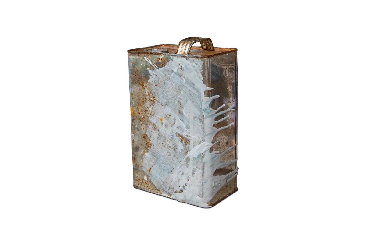 Old metal solvent can with dried white paint drips
