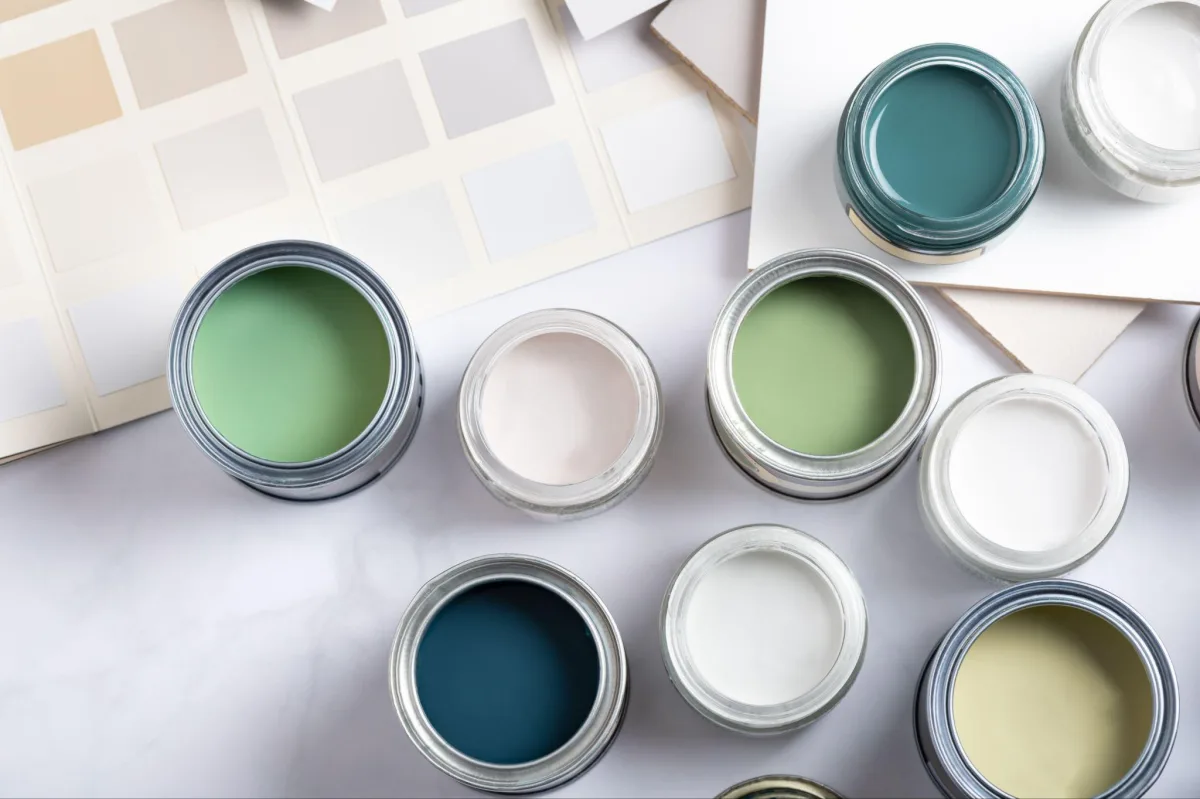 Open cans of low-VOC interior paint in soft green and white