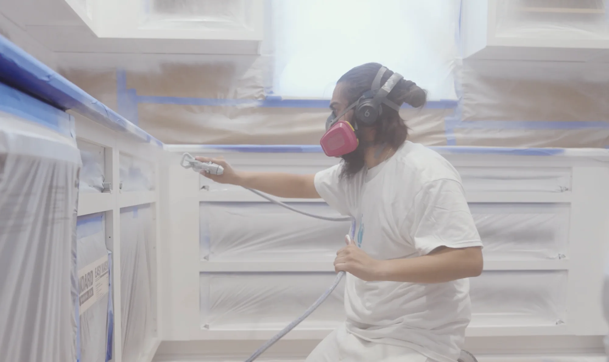 Spraying a factory-smooth finish on kitchen cabinets in Tampa, FL
