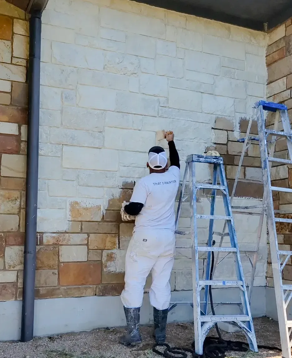Painter brushing limewash onto exterior brick in Fox Chapel - PA to create a soft weathered finish