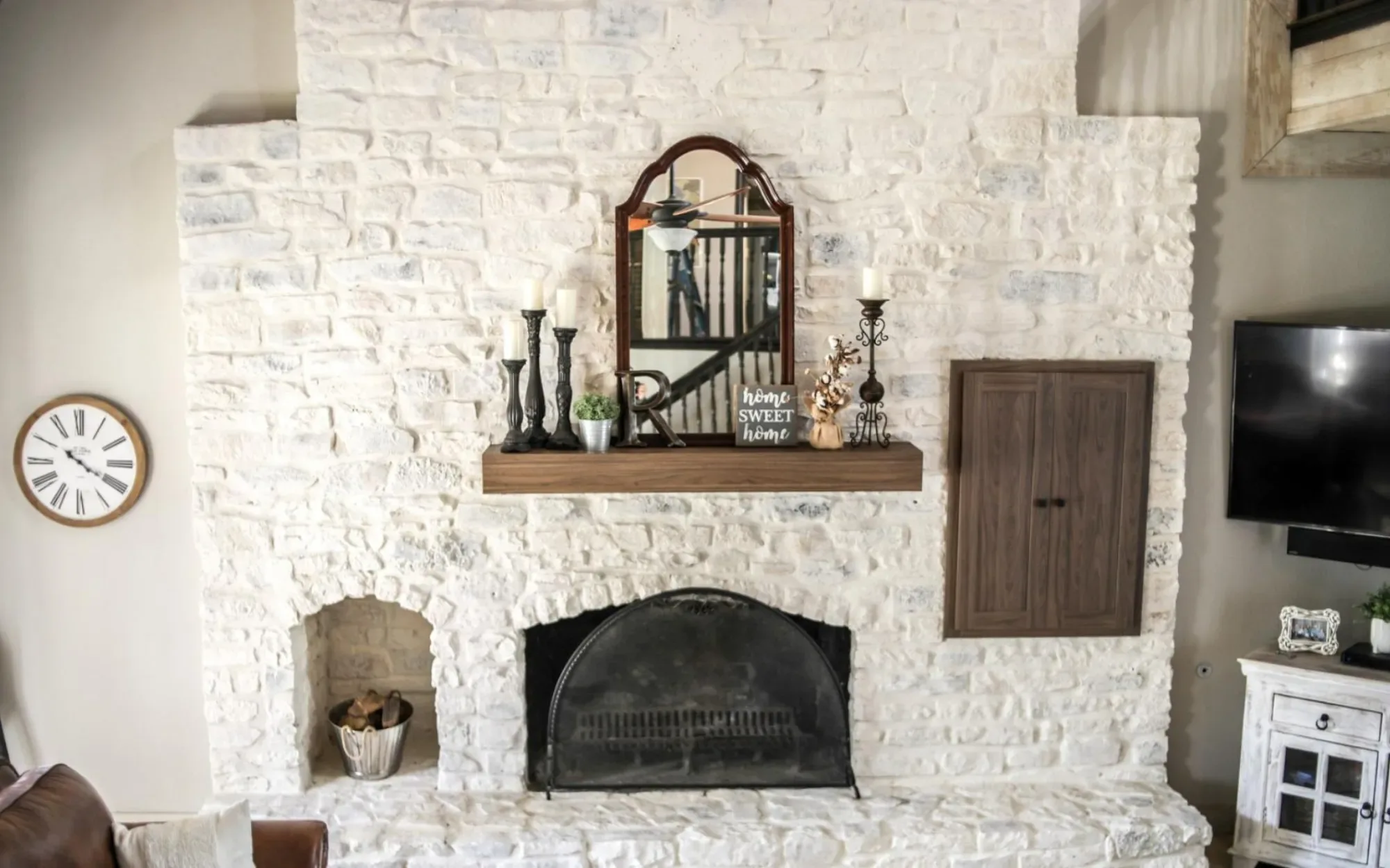 Painter applying limewash to a brick fireplace in Sewickley - PA with careful brush control