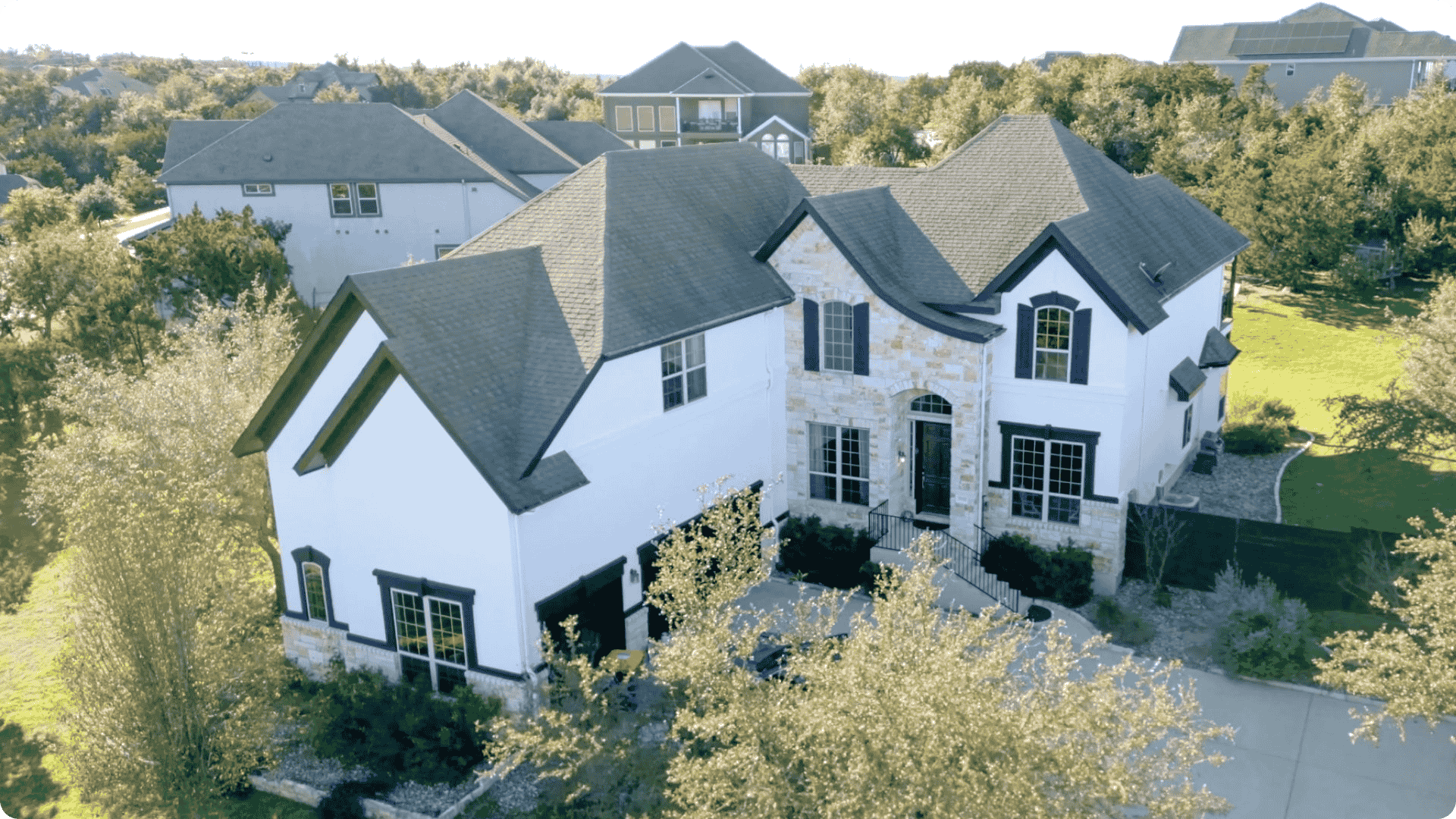 Exterior aerial view of a large white home with gray shingles that was painted by professional painters in Farragut.