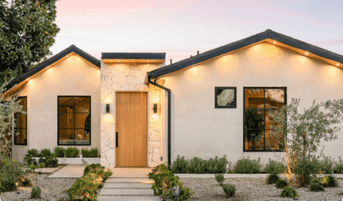 Modern white house with dark trim and upper eaves lighting all finished by painters in Lenoir City