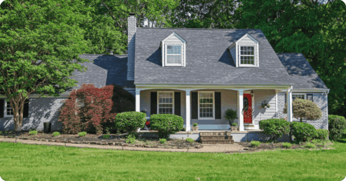 Exterior of a traditional Tennessee brick and siding house with white accents professional painted by painters in Hardin Valley