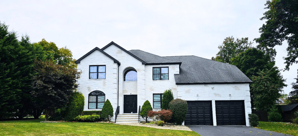 white two story home with white exterior paint and two garage doors for that 1 painter lake lanier