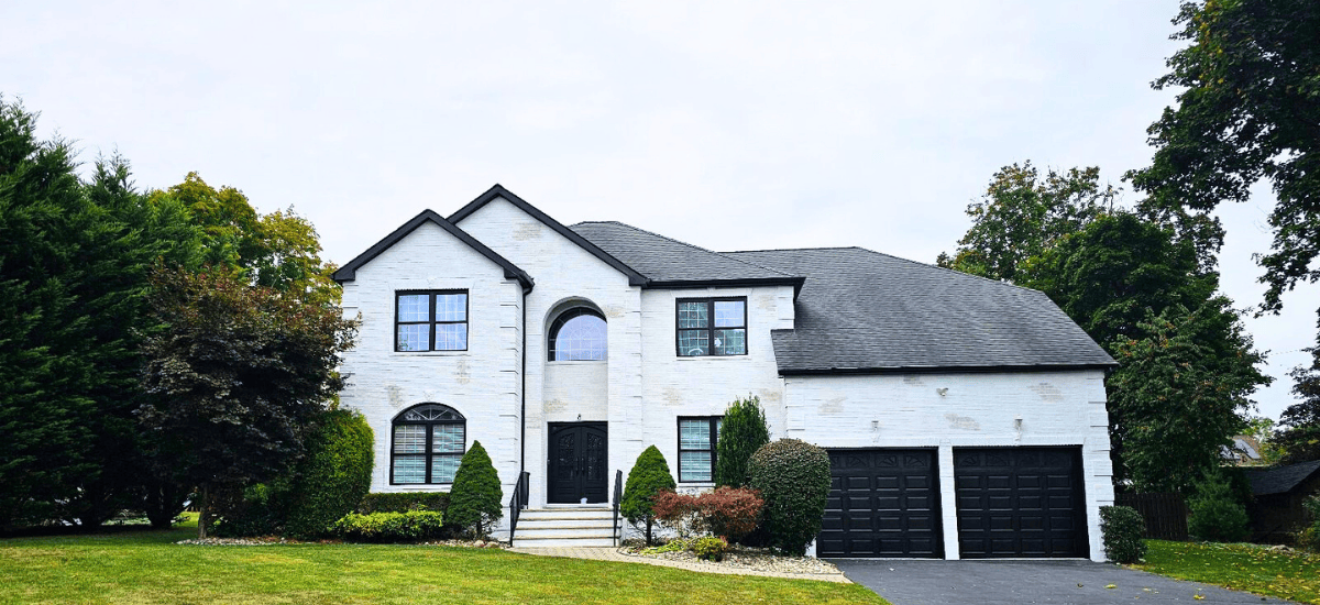 white two story home with white exterior paint and two garage doors for that 1 painter lake lanier