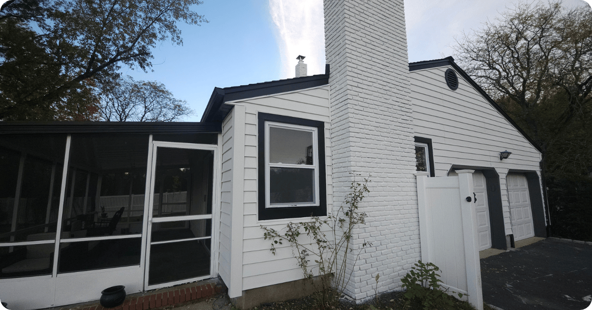 exterior paint job with white paint on a smaller home with trees around it for that 1 painter lake lanier