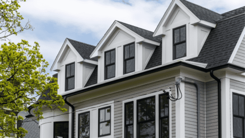 Beautiful white gray siders of the house with white trim painted by professional painters in Norristown, PA
