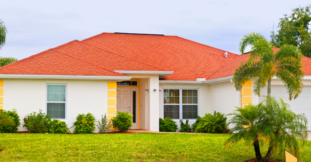 The exterior of a brightly yellow painted home by That 1 Painter Naples.