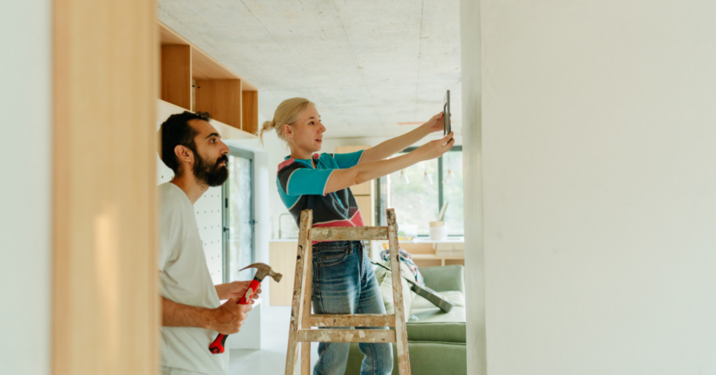 An image of a couple who are DIY-ing a paint project in their home.