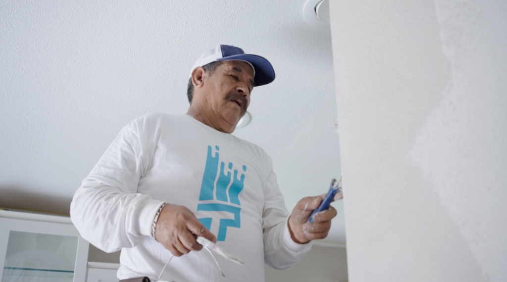 Painter repairing drywall from That 1 Painter New Orleans