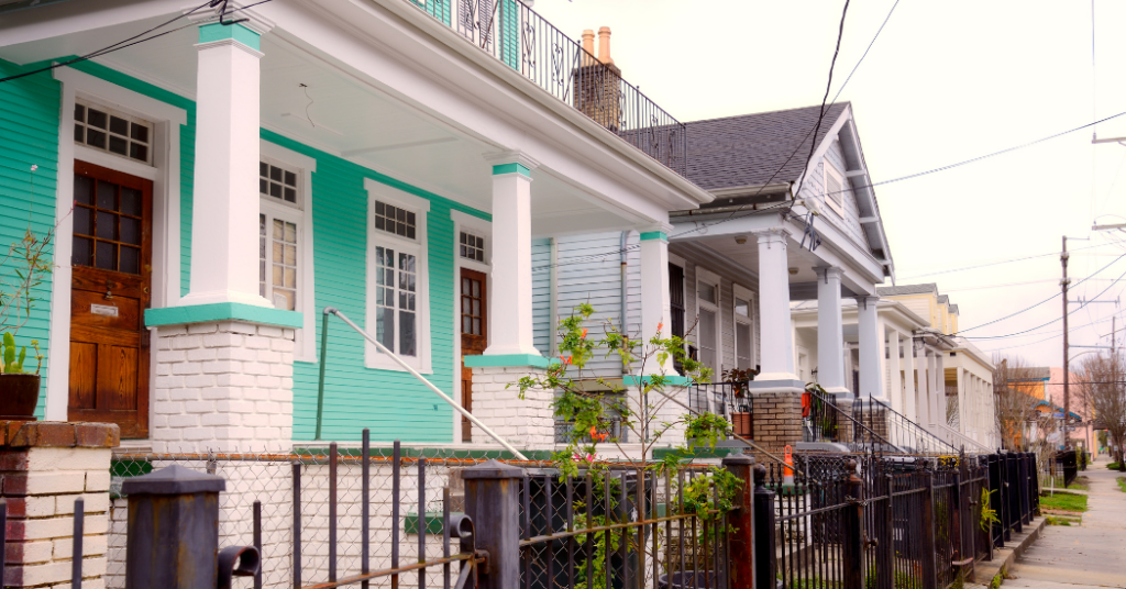 A street full of colorful homes with front fences in New Orleans