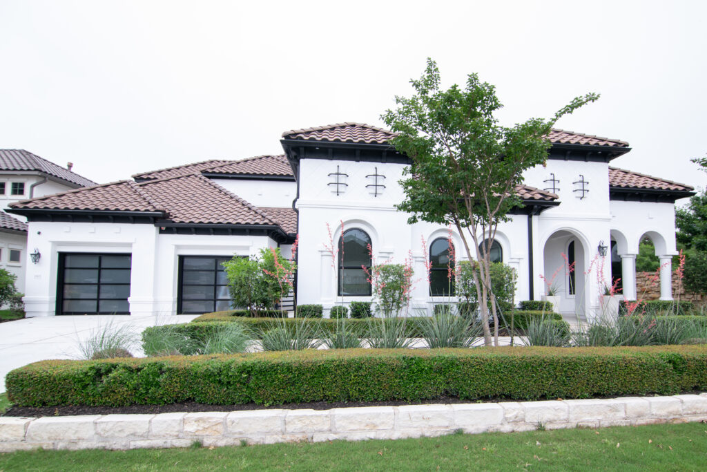 Exterior of a white stucco home in North Atlanta featuring repair work done by That 1 Painter