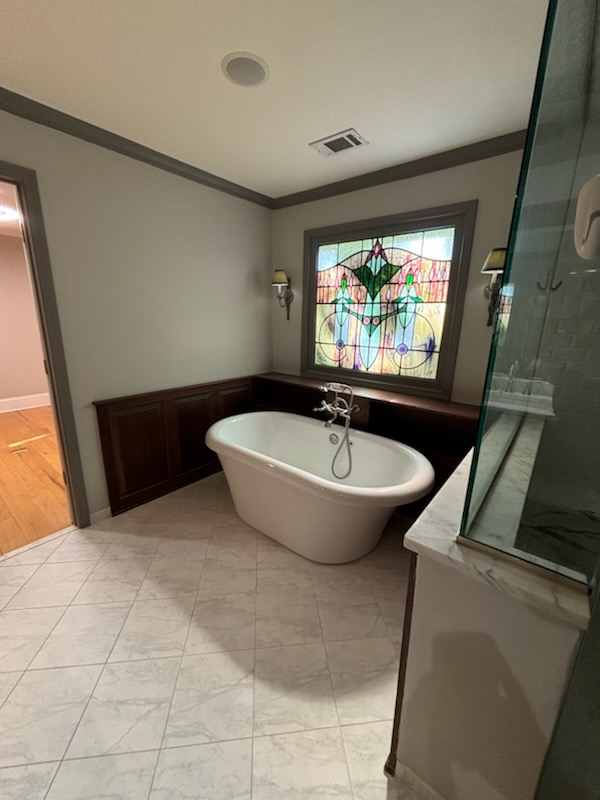 stained glass window featured in a modern bathroom interior painted by professional painter