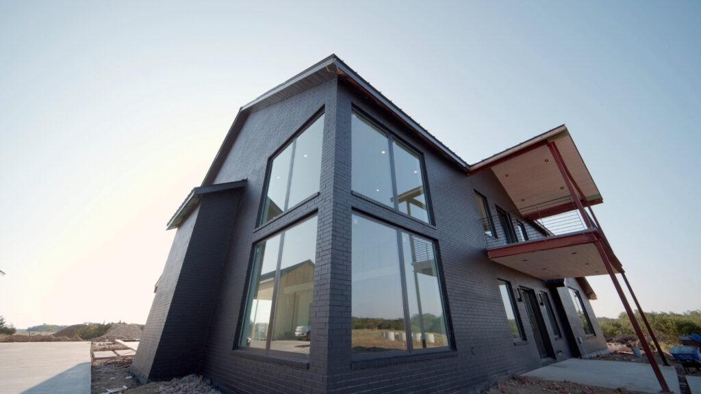 tall house with big windows painted the exterior black by that 1 painter northern Kentucky
