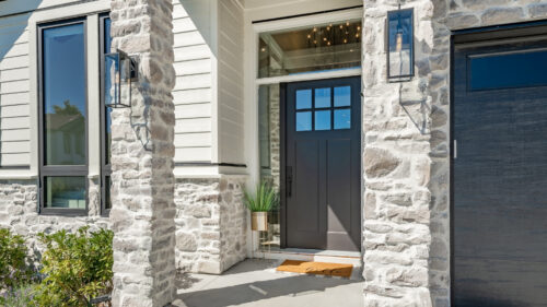 Close up shot of an exterior home front door with tan siding all painted by house painters in El Reno