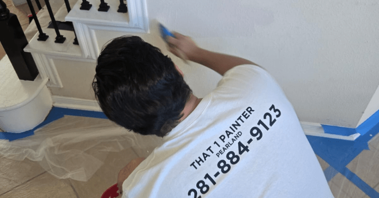 Professional painter from That 1 Painter Pearland painting the bottom of a staircase
