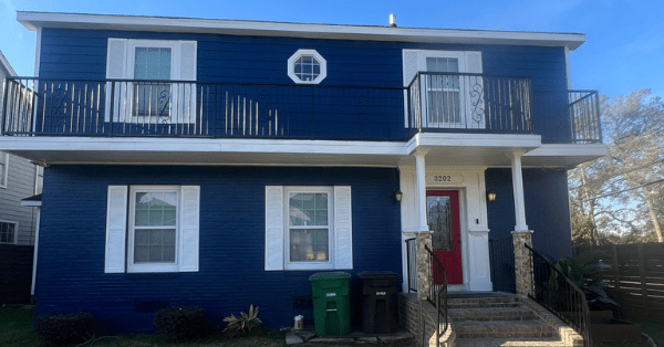 a two story home displaying exterior painting trends with a navy blue paint job_that 1 painter