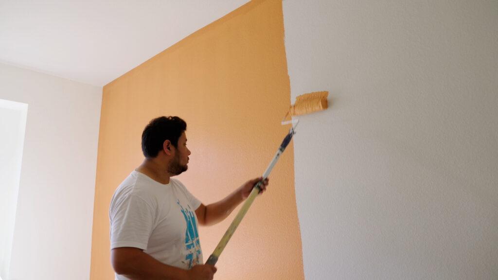 professional painter painting an interior wall orange_that 1 painter pearland