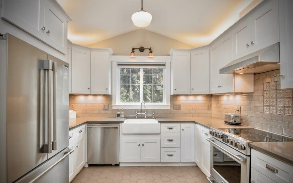 Modern white kitchen painted by professional painters following the KCMA standard cabinet painting system