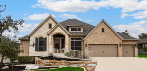 Exterior tan brick home with light tan accents painted by professional painters in Kyle