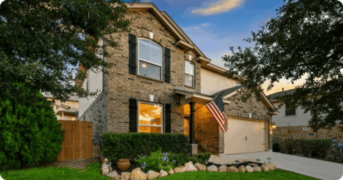 Brick and light painted exterior of a house painted by professional painters in Manchaca