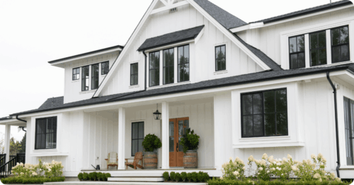 A modern white house with dark accents painted by house painters in Frierson, LA