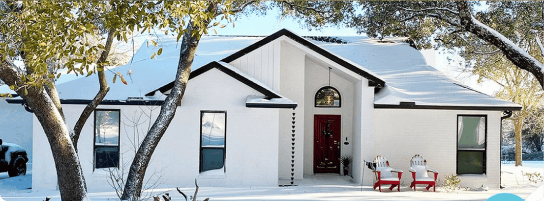 snowy home with white exterior paint and tree in that 1 painter south denver