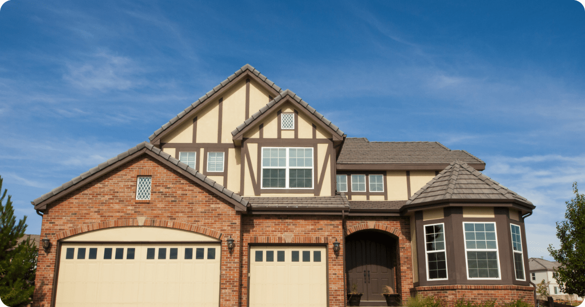 Exterior painting in South Denver of a snow-covered neighborhood showcasing two-story gray homes with white trim and pitched roofs by that 1 painter