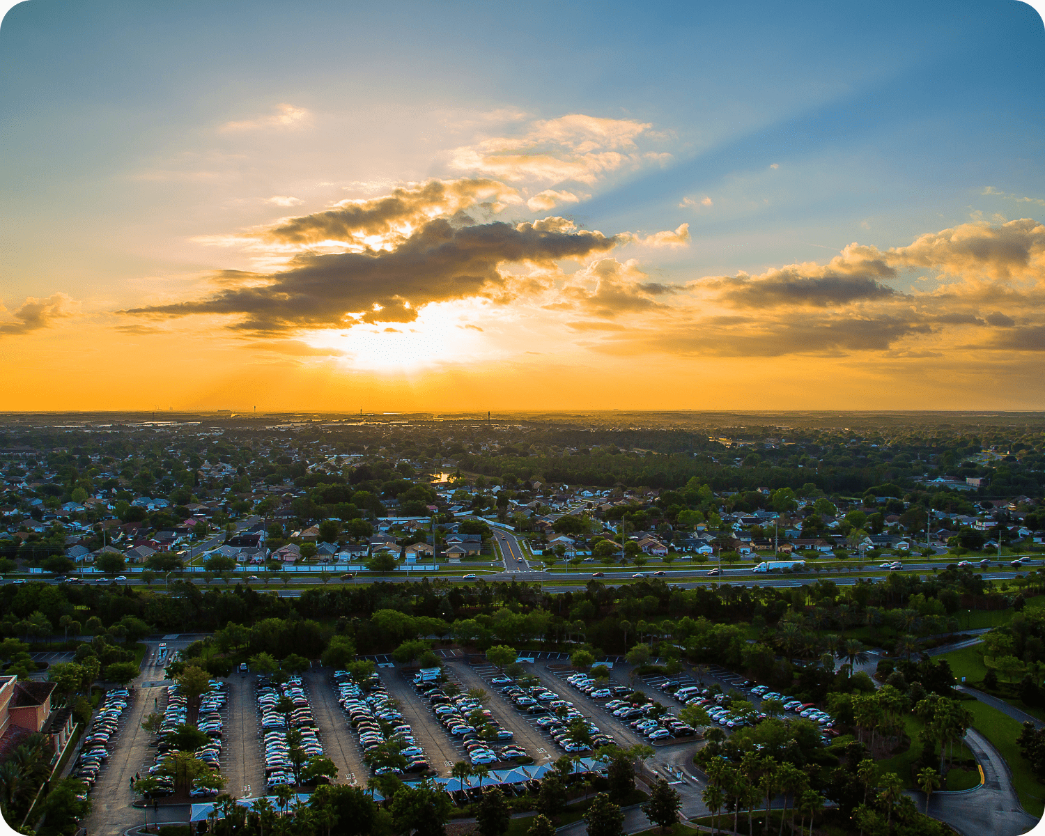 Exterior painting in South Orlando highlighting a Tuscan-inspired home with peach-toned stucco, terracotta tile roof, arched entryway, and manicured front yard by that 1 painter.