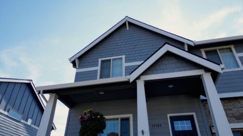 Beautifully done exterior painting of a gray house by professional painters in Brunswick, ME