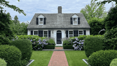 Beautiful white house with landscaped surroundings painted by professional painters in Hampton, NH.