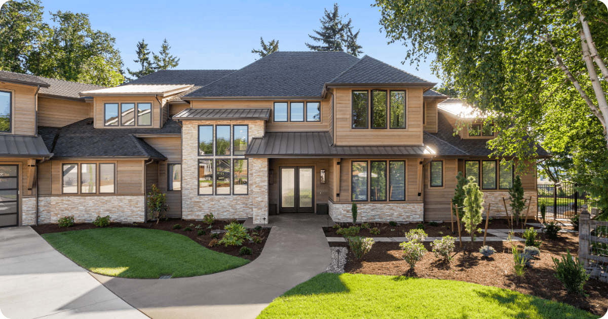 Exterior painting in Southlake, TX of a contemporary home with natural wood siding, stacked stone accents, large pane windows, and metal roofing by that 1 painter.