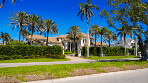 Exterior yellow tan home with palm trees painted by Professional painters in Tampa Heights, Florida, Tampa Bay