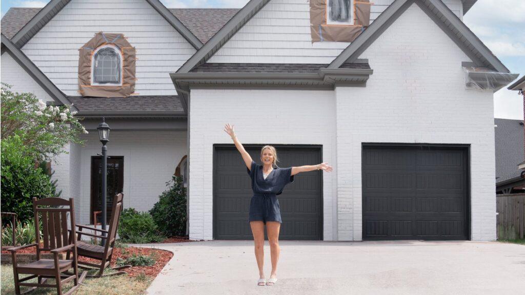 Woman outside her home celebrating new white limewash service in minneapolis_that 1 painter twin cities