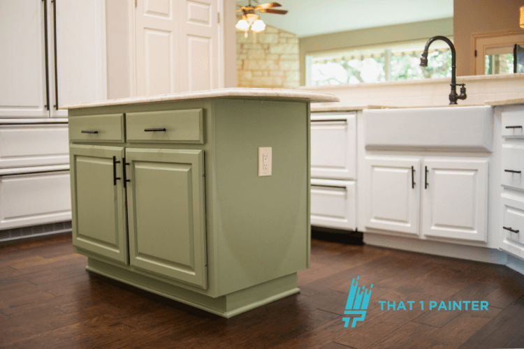 A professional from That 1 Painter painting kitchen cabinets as part of interior painting services in North Minneapolis. The image highlights the expertise of North Minneapolis Interior Painters, offering high-quality cabinet painting to transform your kitchen and home with the best professional painters in North Minneapolis, Minnesota.