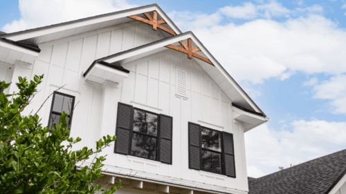 Freshly painted white exterior paired with stained wooden top trim by professional painters in St. Louis Park, MN