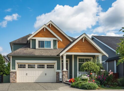 Freshly painted modern two-story house with double garage, patio, painted siding, and white trim by professional painters in Maple Grove, MN