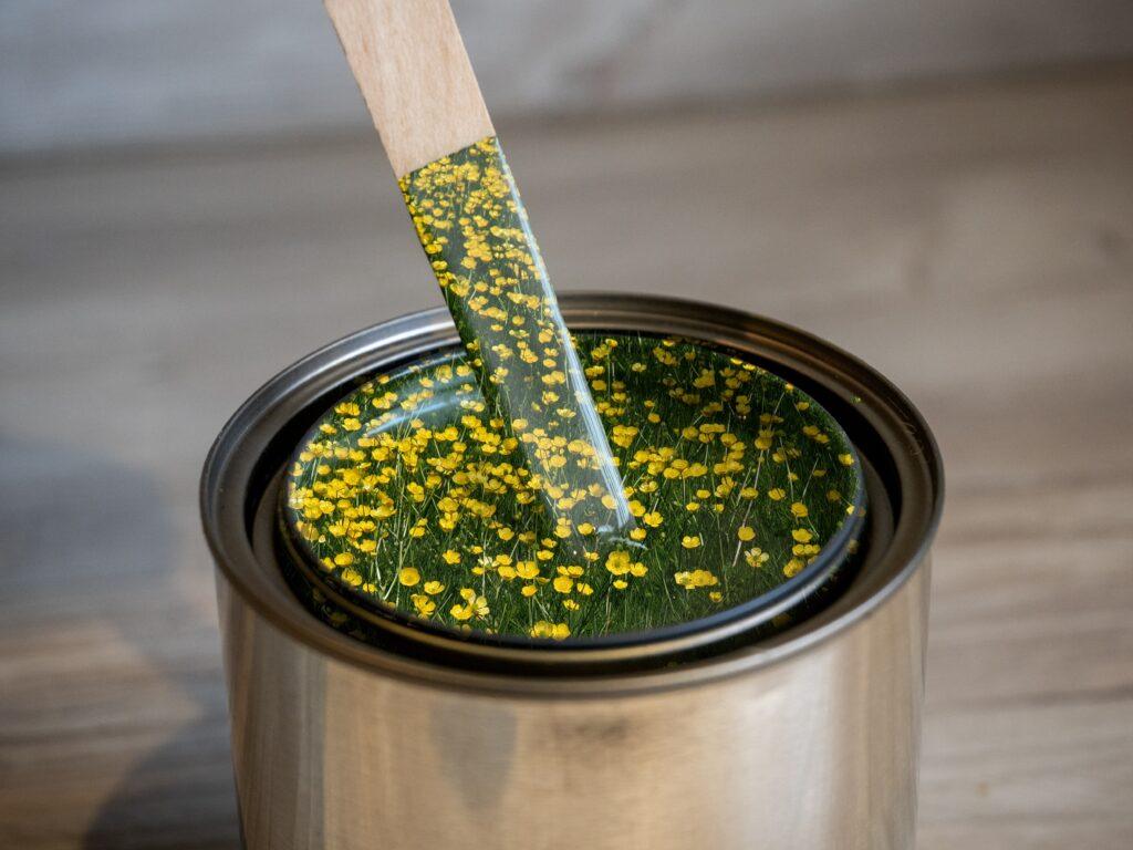 a paint bucket with a picture of flowers that gives the illusion of paint for eco-friendly paint
