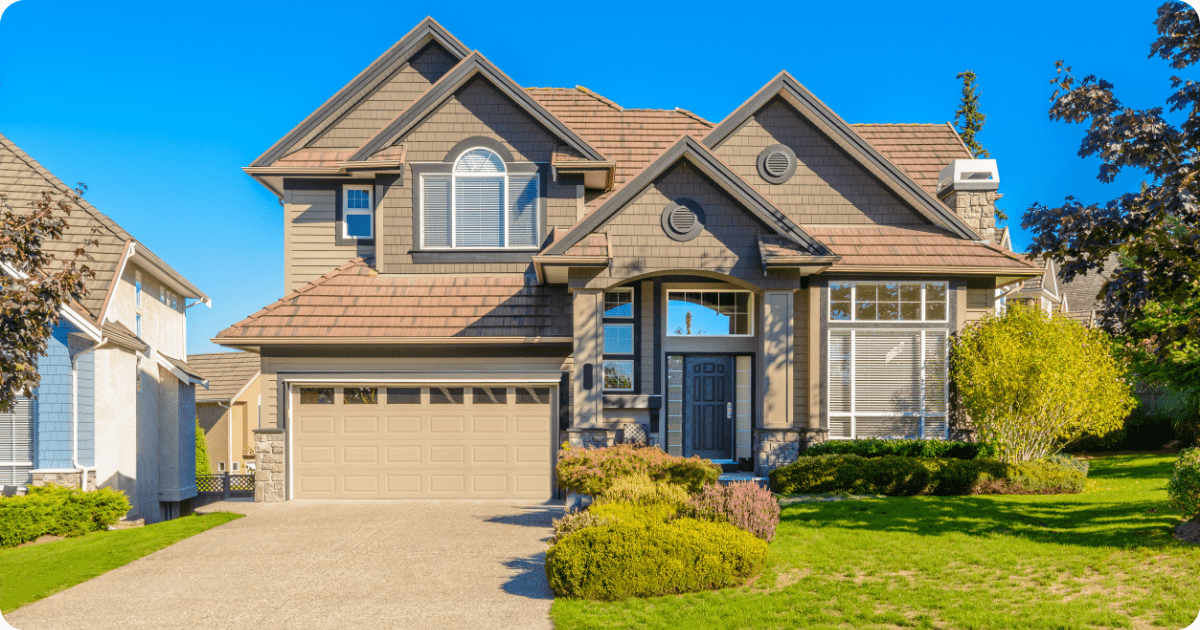 Exterior painting in Wadsworth, OH of a single-story ranch home with white siding, beige shutters, brick accent facade, and a neatly landscaped front yard with vibrant shrubs and green lawn by that 1 painter.