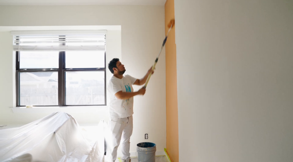 That 1 Painter painting an accent wall in a prepped room.