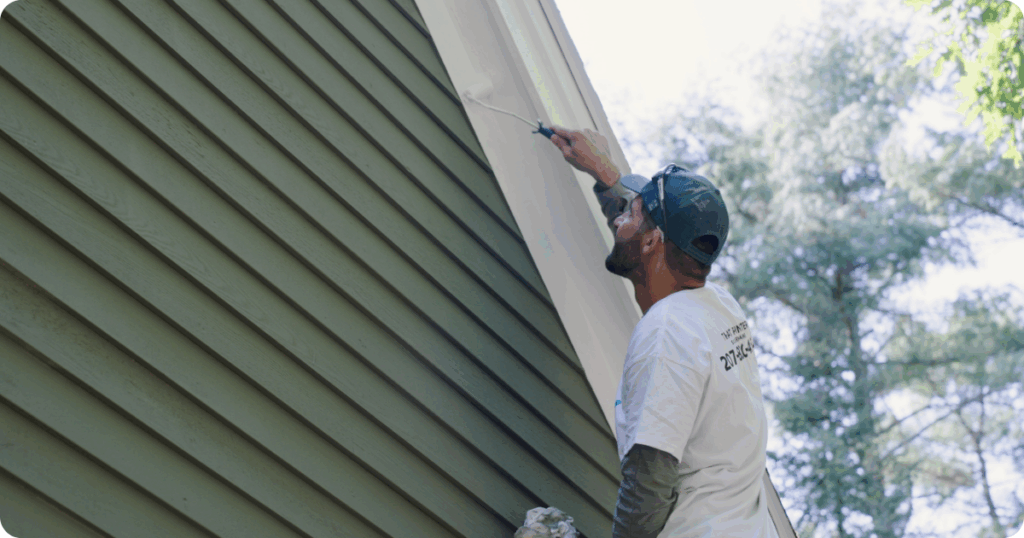 exterior painting done by professional painters-expert painter painting the exterior of a modern home from that 1 painter