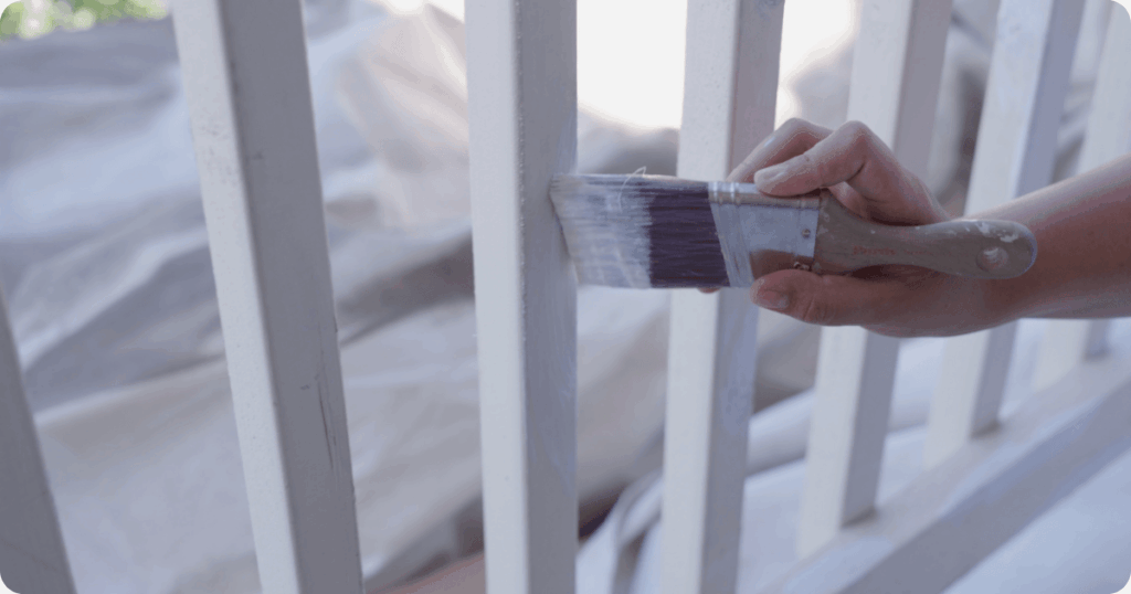 fence staining-white fence being painted with brush by that 1 painter professional painters
