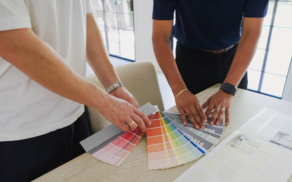 2026 Kitchen Cabinet Painting: How to Get the Most Money for Your House 2 cabinet painting color consultation with two people holding painting swatches